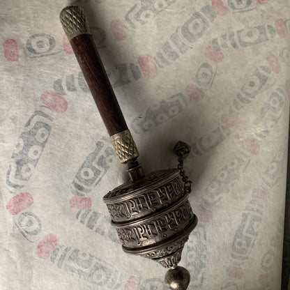 An antique Tibetan handheld prayer wheel