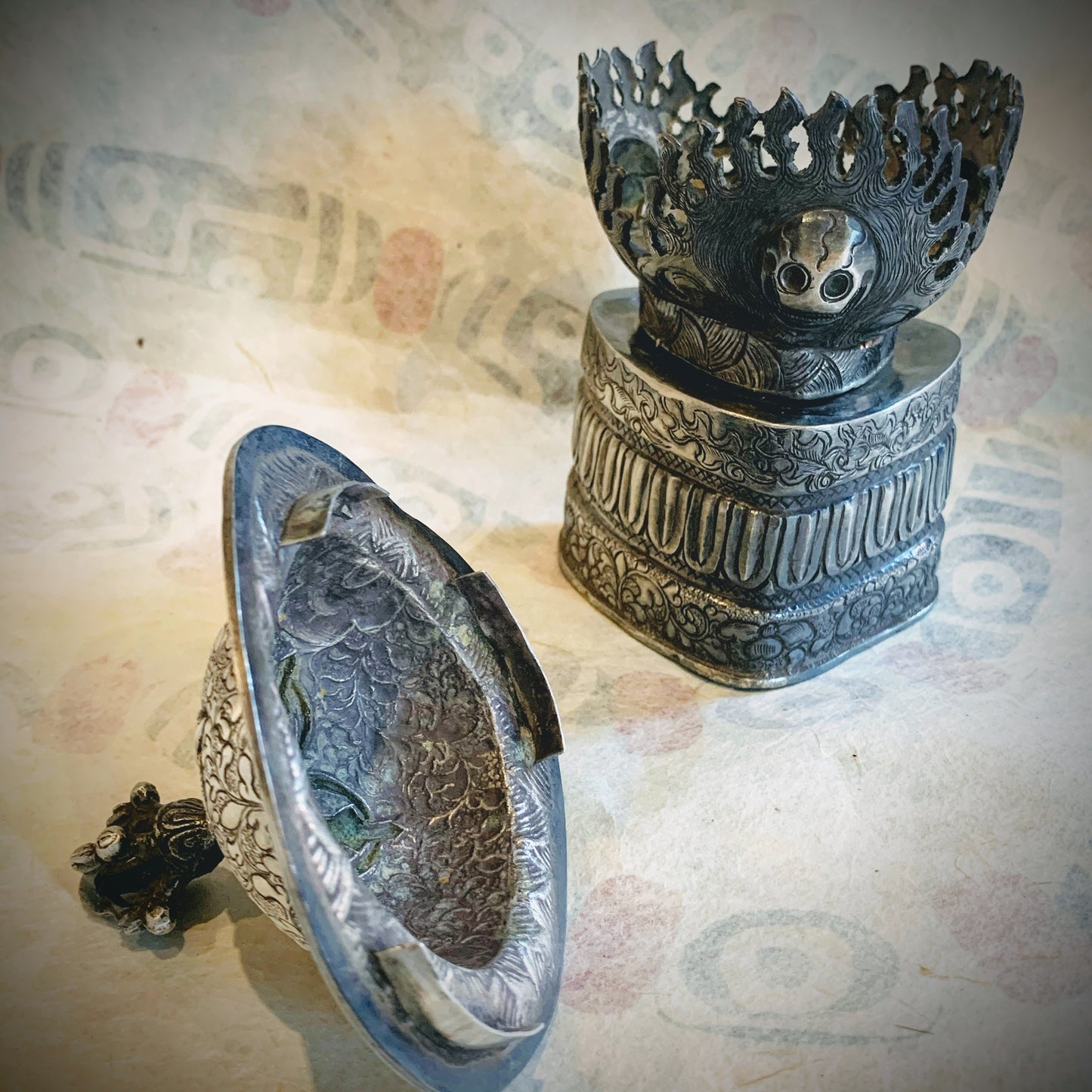 An antique silver kapala stand and cover