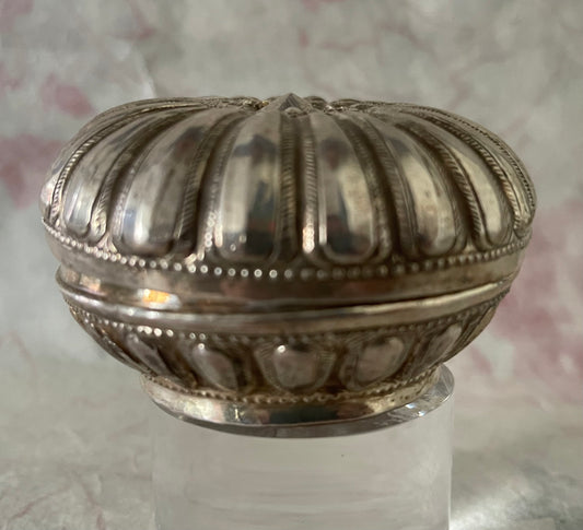 An antique silver south East Asian round box with lid