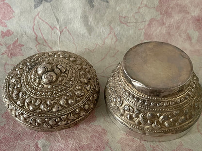 An antique silver south East Asian round box with lid