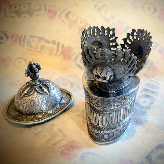 An antique silver kapala stand and cover