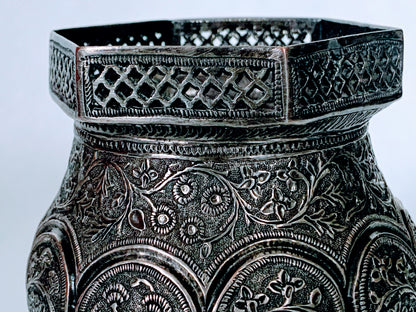 An exquisitely carved antique silver utensil -possibly a censer with floral details
