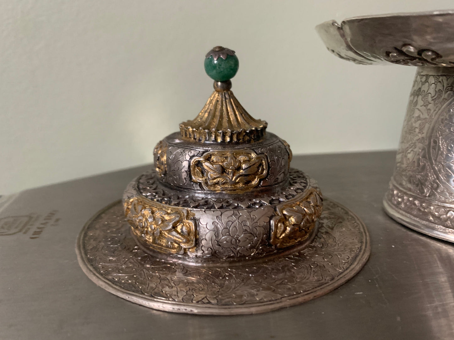 A silver cup stand