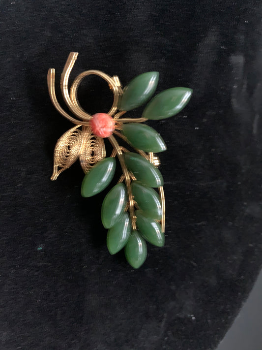 A jade and coral brooch