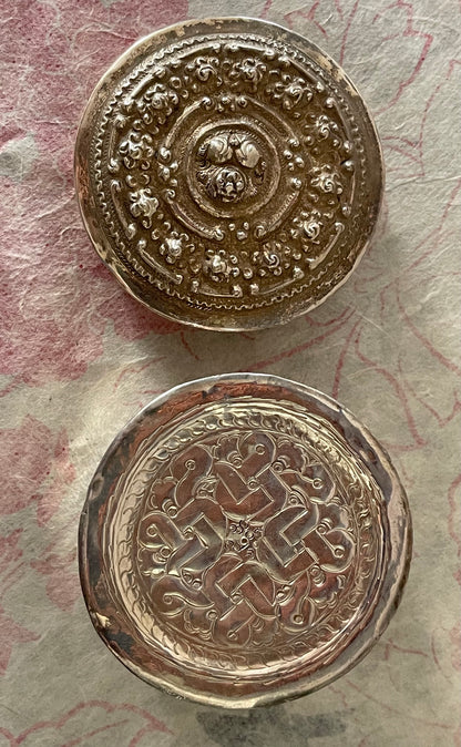 An antique silver south East Asian round box with lid