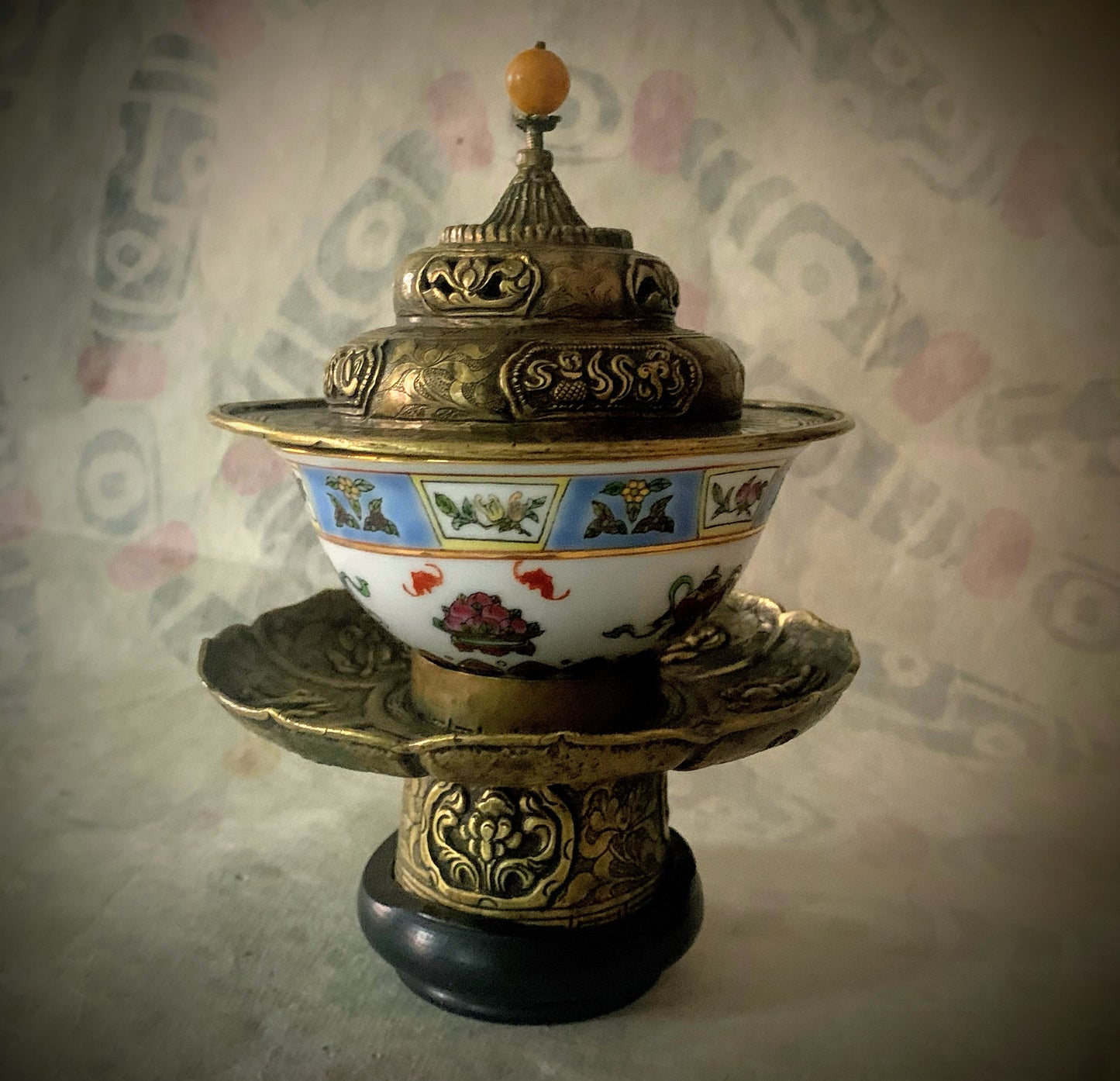 An antique metal cup stand