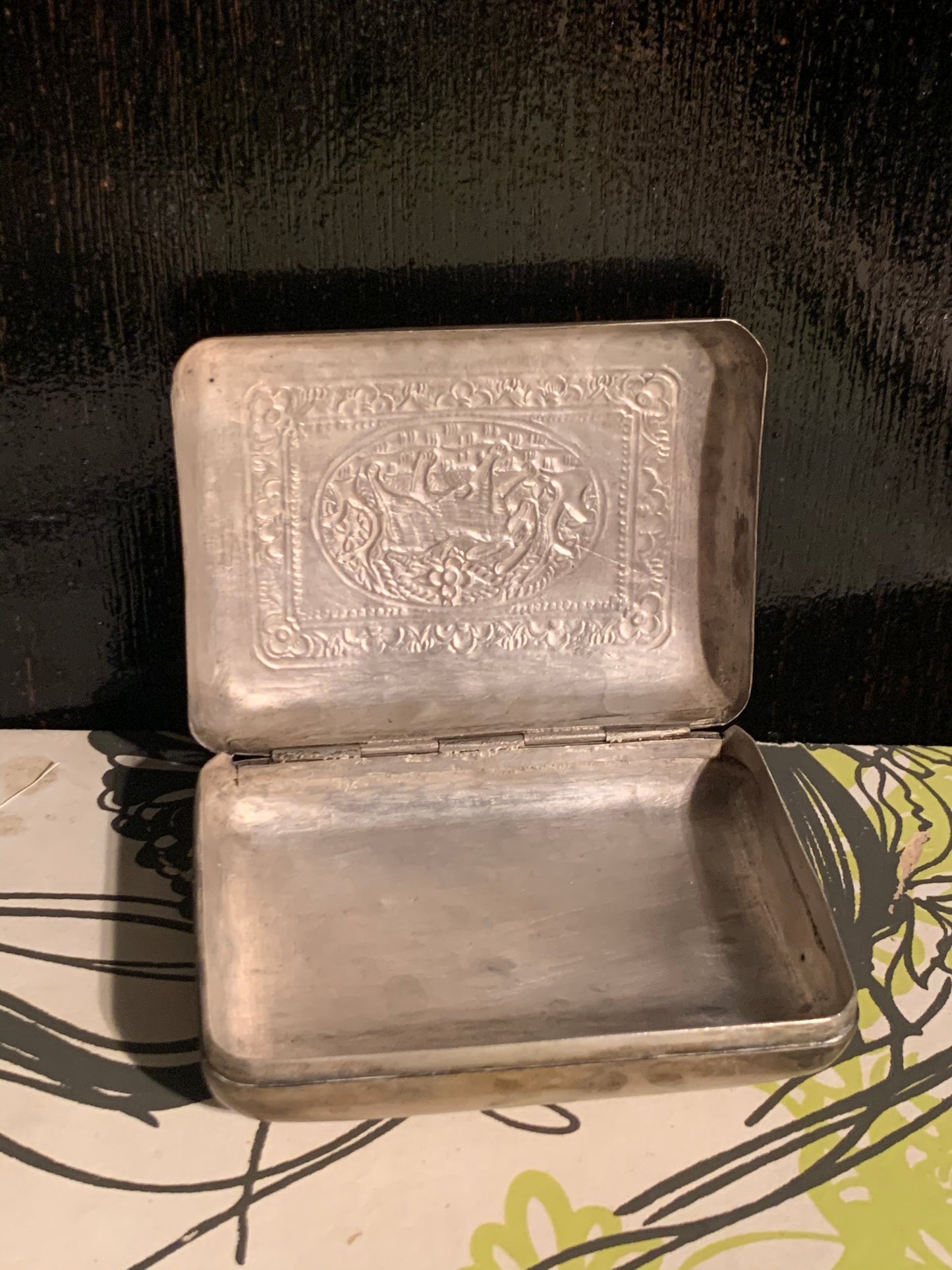 A silver box with hinged lid