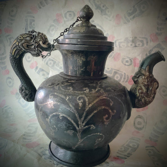 An antique Tibetan iron and silver teapot