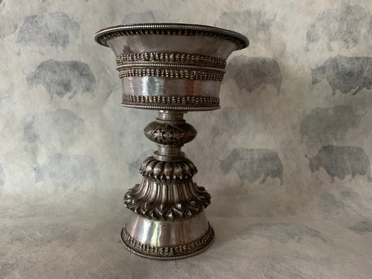 An antique Tibetan silver butterlamp