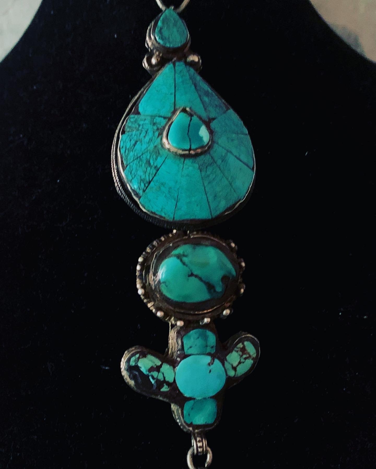 An antique turquoise and silver Tibetan ear pendant / earring