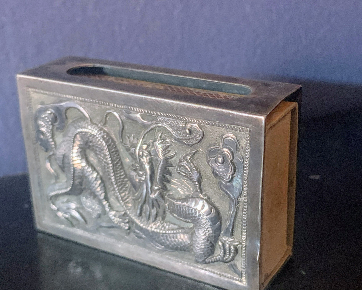 A silver matchbox cover