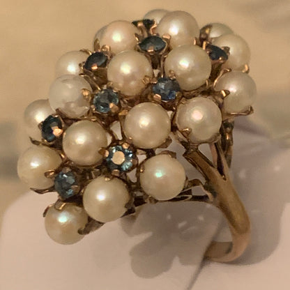 A pearl and sapphire ring in a 14kt setting
