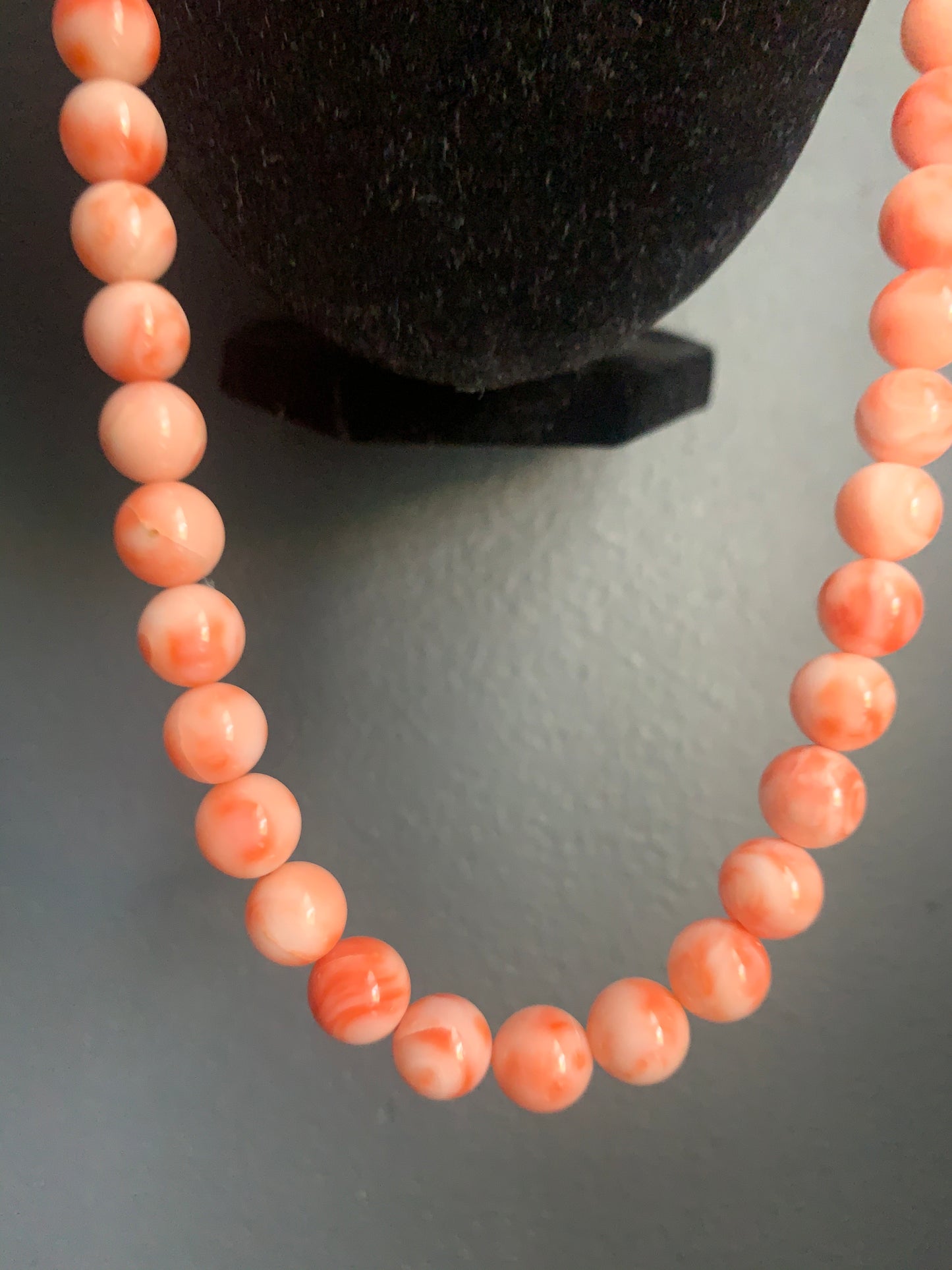 A salmon colored coral -like bead necklace
