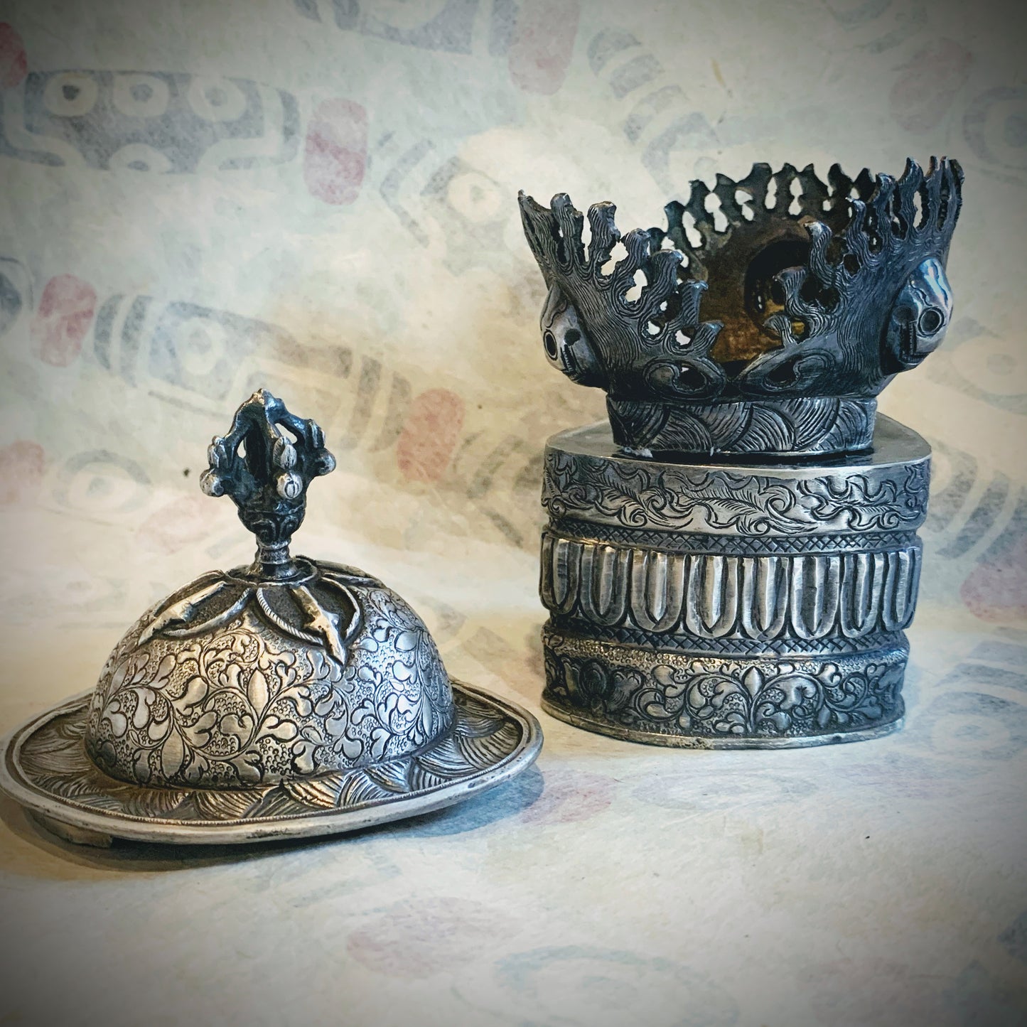 An antique silver kapala stand and cover