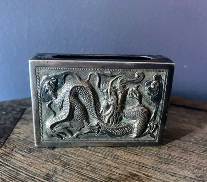 A silver matchbox cover