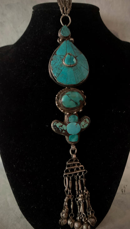 An antique turquoise and silver Tibetan ear pendant / earring
