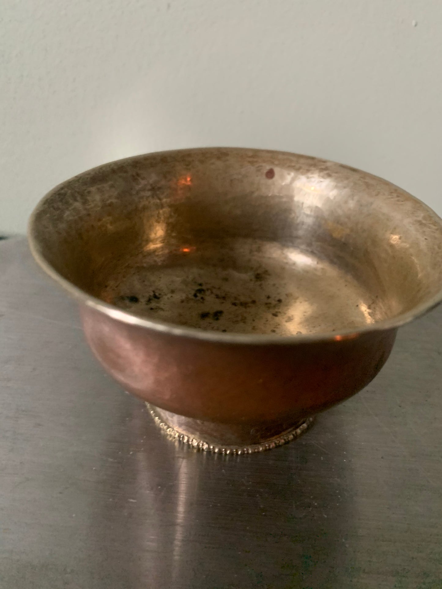 A copper bowl With silver details