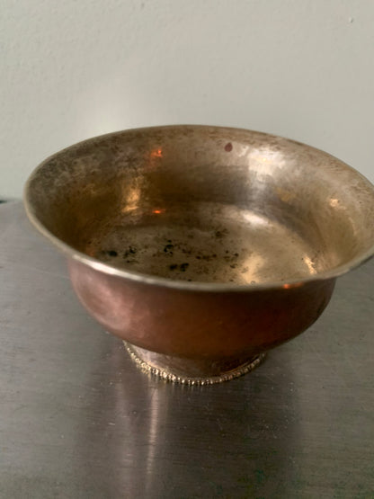 A copper bowl With silver details