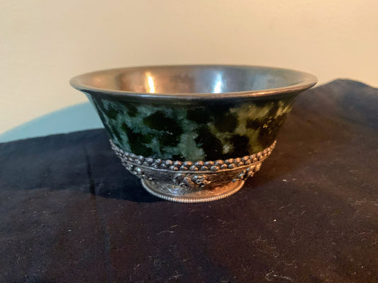 A jade bowl with silver details