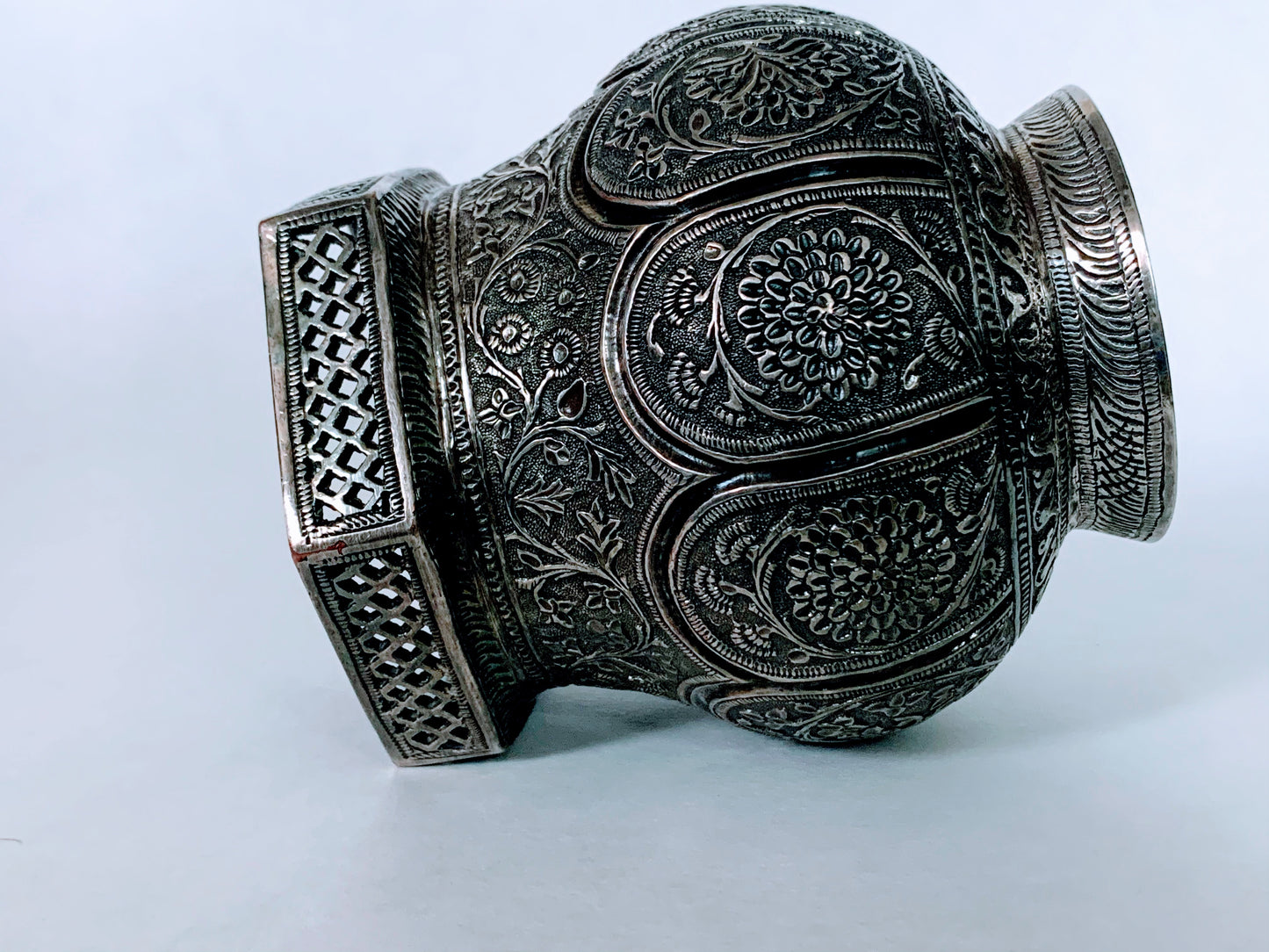 An exquisitely carved antique silver utensil -possibly a censer with floral details