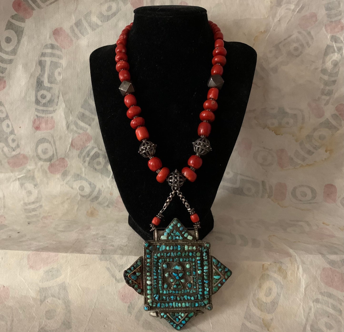 A vintage Tibetan silver and turquoise ghau pendant with an antique red coral bead and silver bead necklace