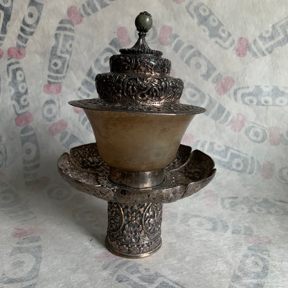 A silver Tibetan cup stand