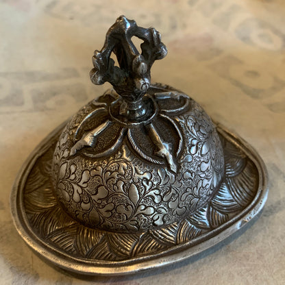 An antique silver kapala stand and cover