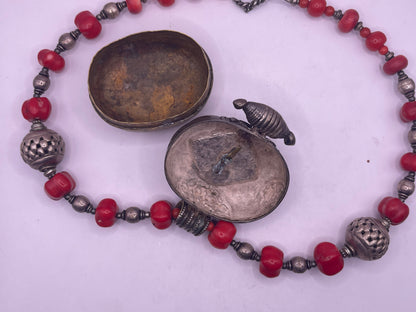 Antique Tibetan coral ghau pendant with a coral and silver necklace