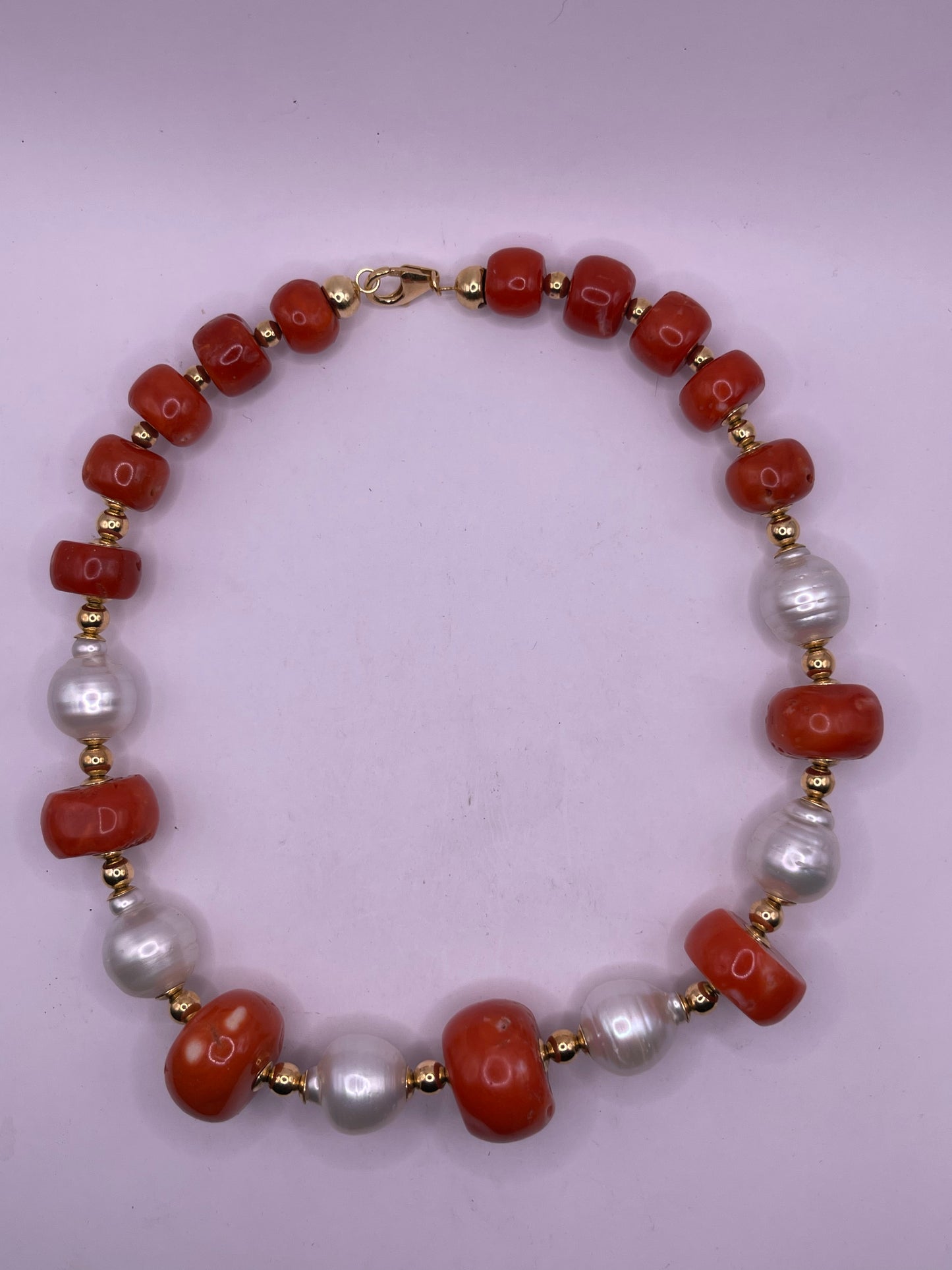A vintage coral, pearl and gold bead necklace