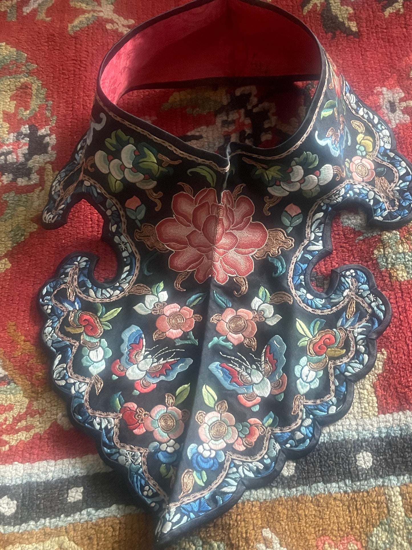 An unframed embroidered antique collar