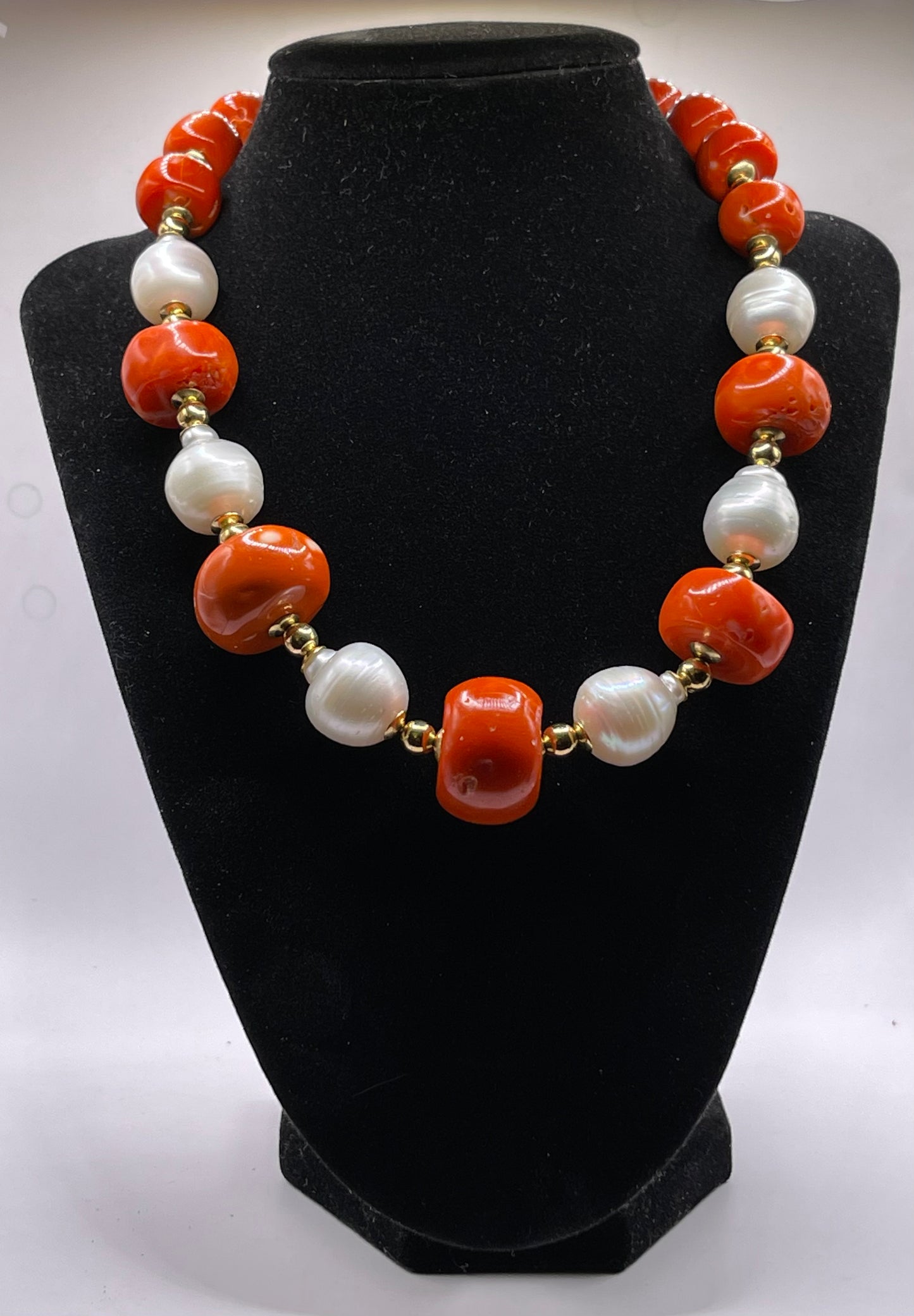 A vintage coral, pearl and gold bead necklace