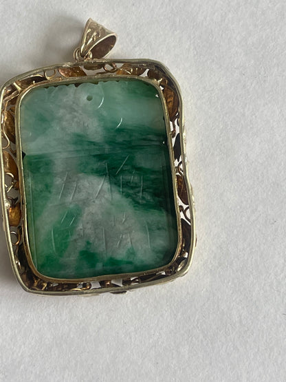 A vintage pendant with a jade plaque in a 10 kt setting