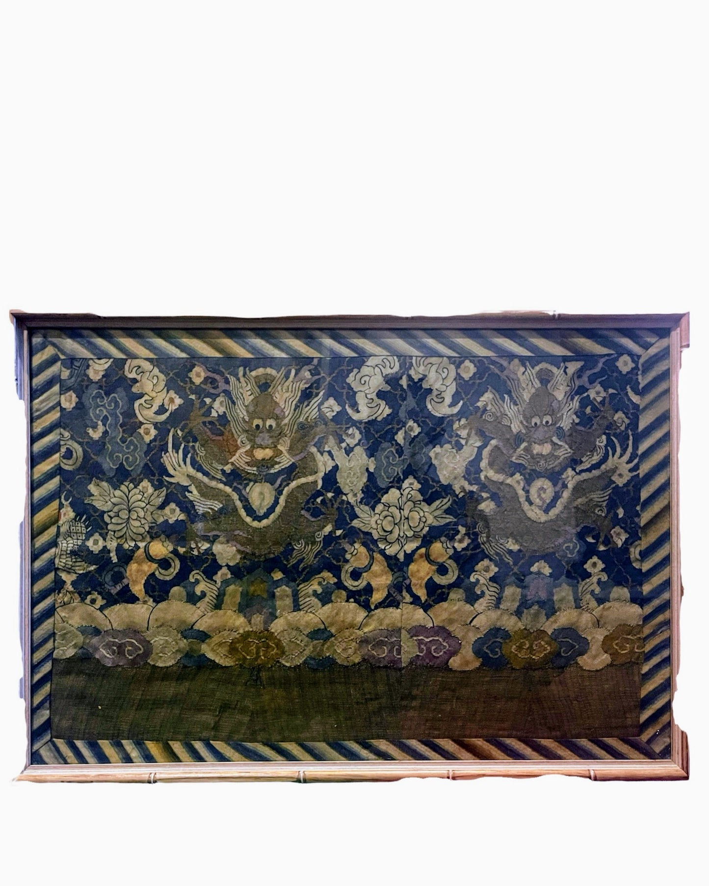 An antique framed Chinese silk kesi of a pair of dragons