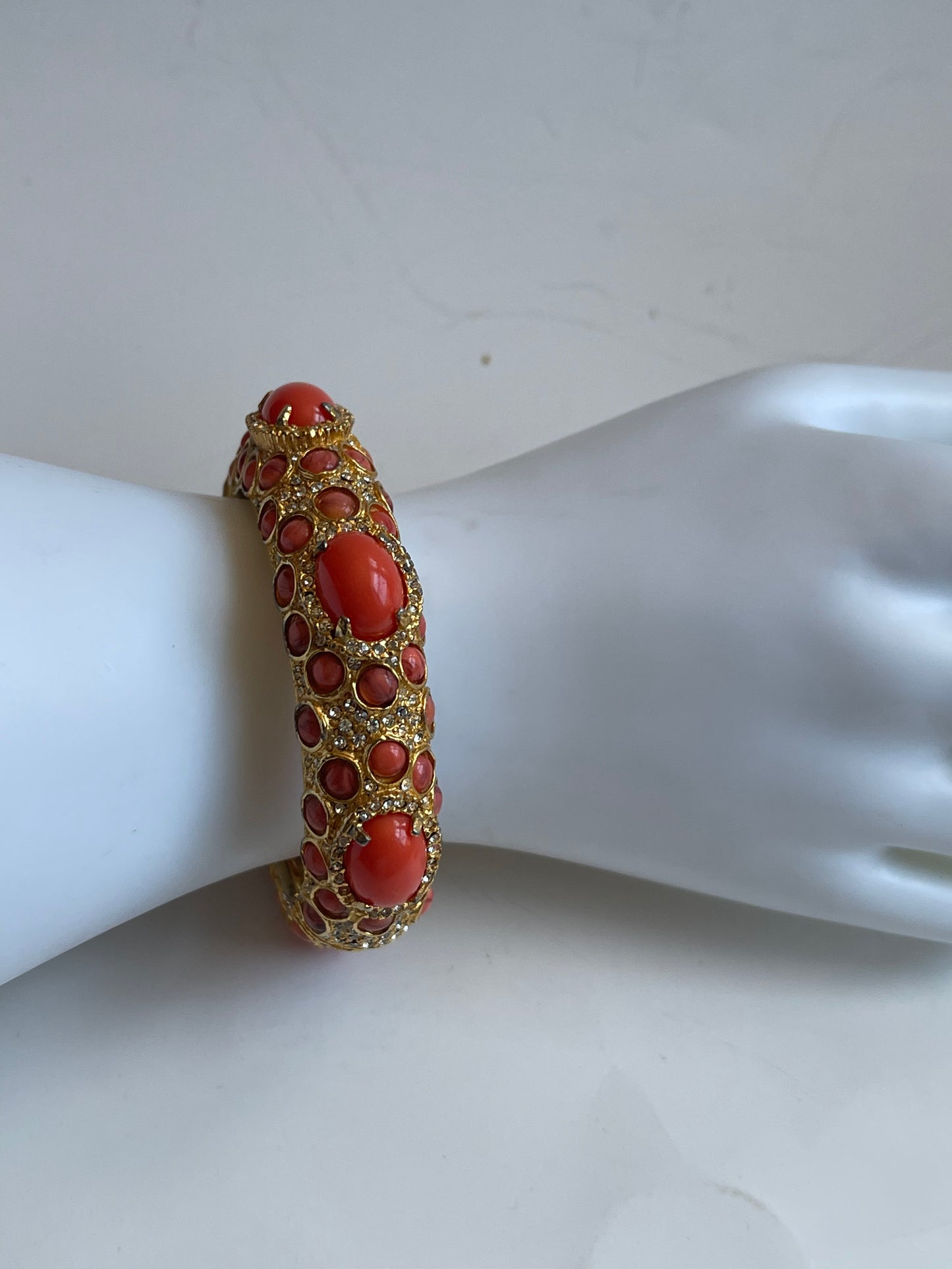 A vintage KJL coral like bracelet with rhinestones