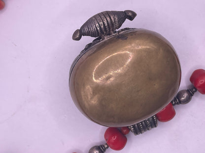 Antique Tibetan coral ghau pendant with a coral and silver necklace