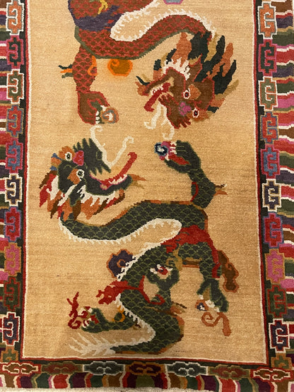 A vintage mid 20th c. Tibetan rug with dragons