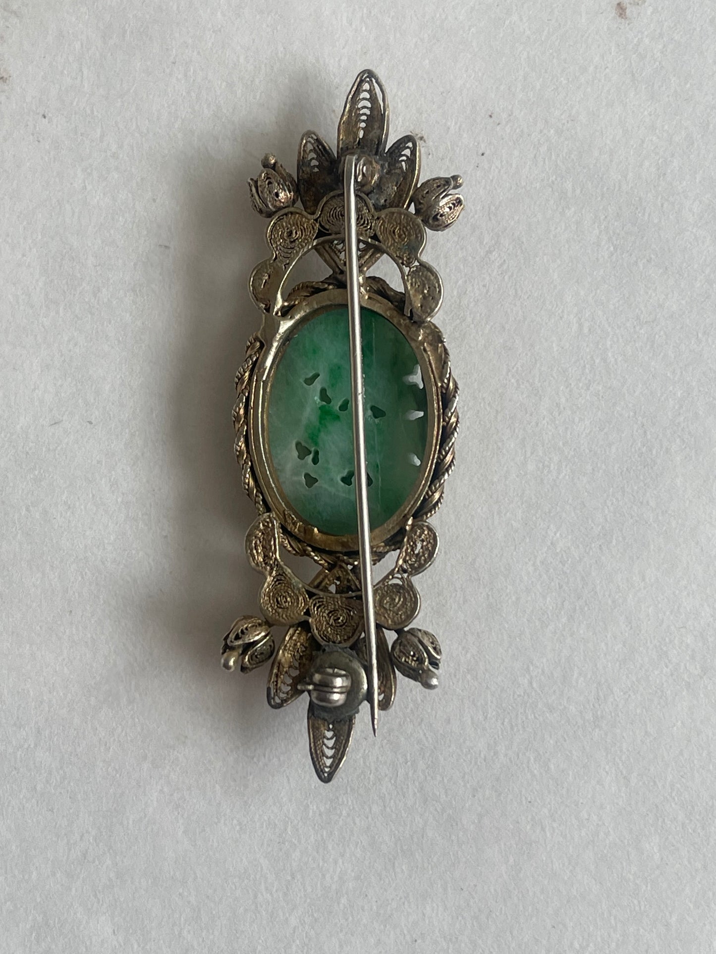 A vintage jade brooch In a gilded silver setting