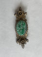 A vintage jade brooch In a gilded silver setting