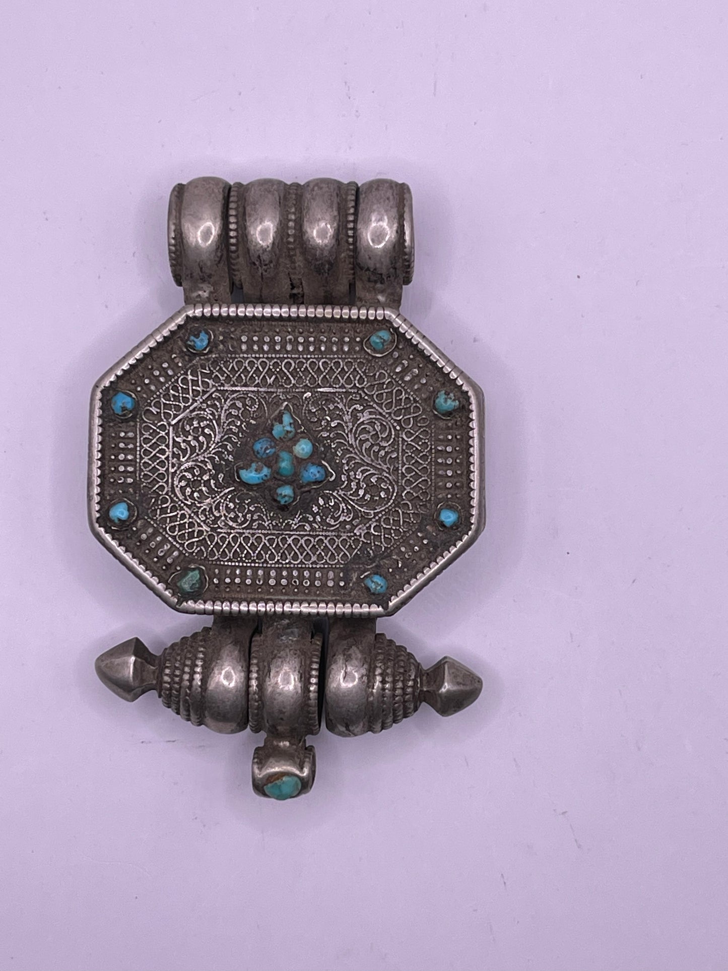 An antique 19th C., few Tibetan silver ghau with silver filigree and turquoise.