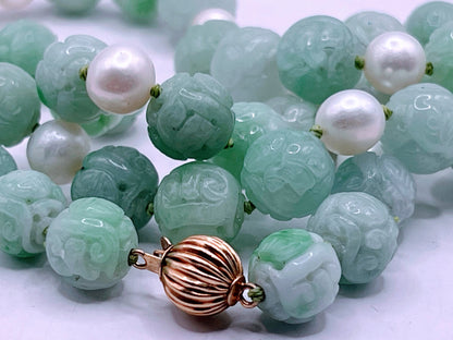 A necklace with vintage carved jade shou beads and pearls