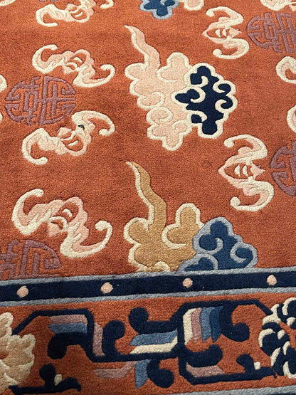 A mid 20th C. Peking rug with clouds and bats motifs