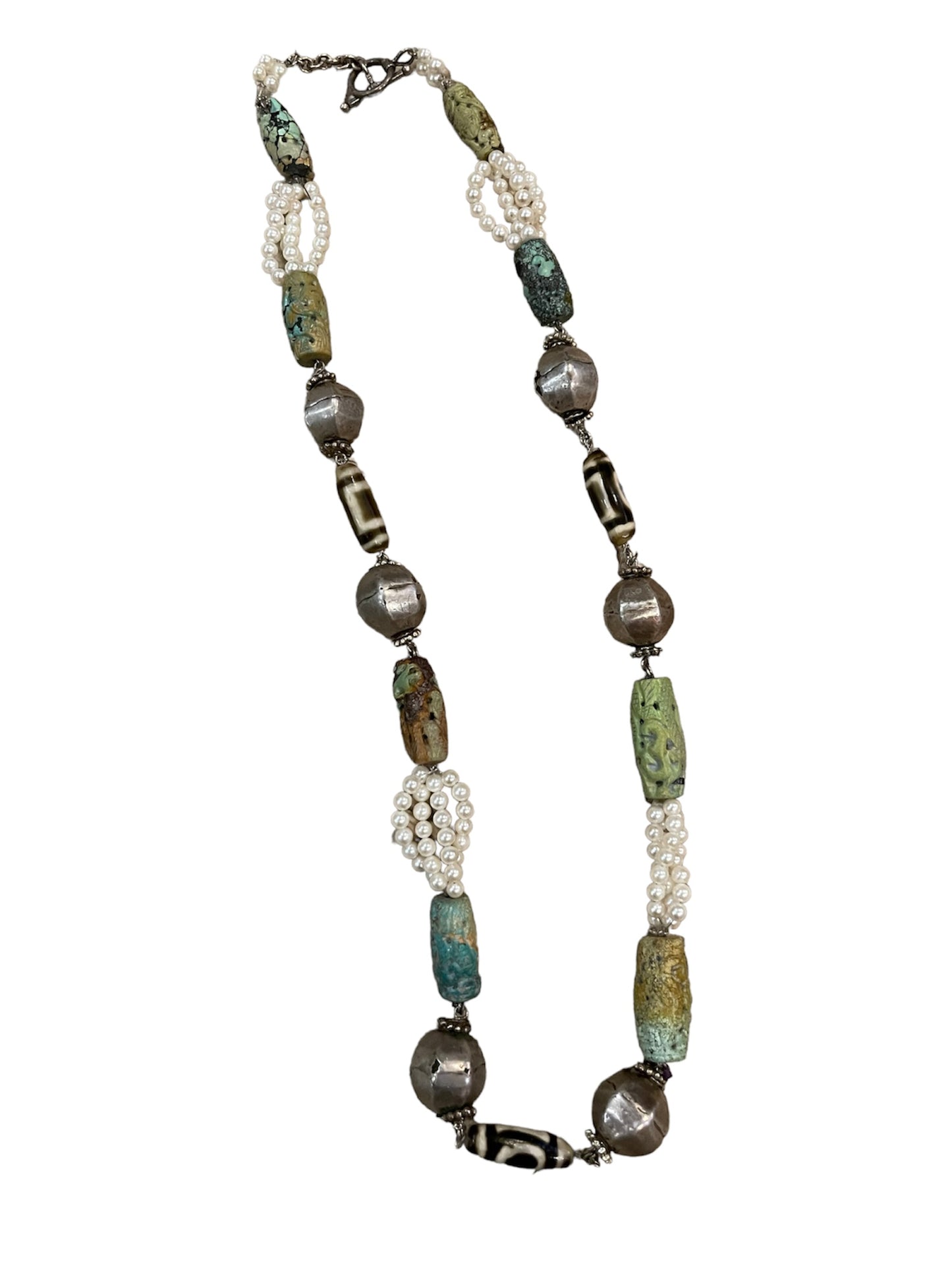 A necklace with antique turquoise, pearls and silver beads