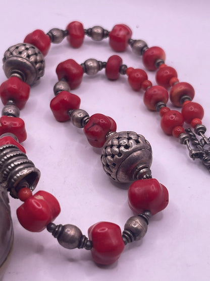 Antique Tibetan coral ghau pendant with a coral and silver necklace