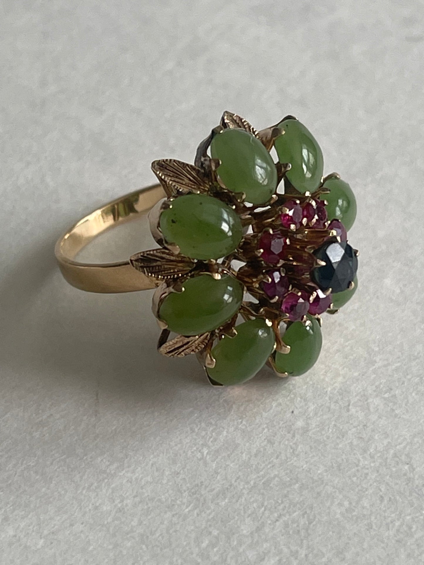 A vintage jade, ruby and sapphire cocktail ring