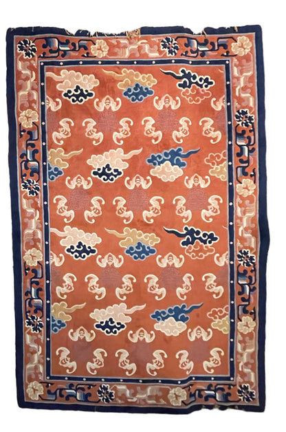 A mid 20th C. Peking rug with clouds and bats motifs
