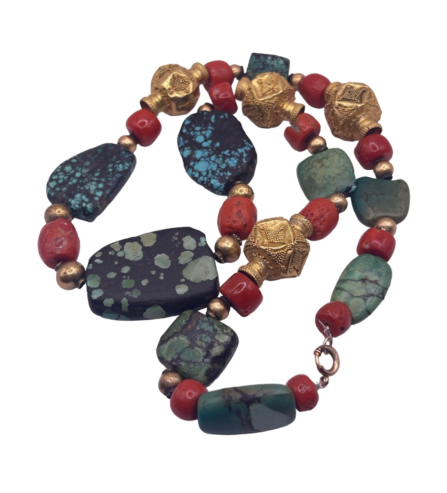 A necklace with antique Tibetan turquoise beads, coral beads and gold beads