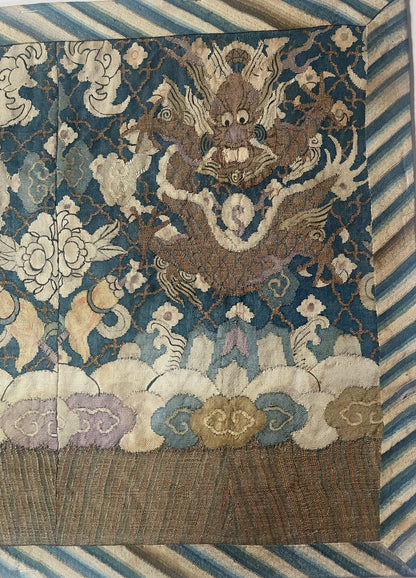 An antique framed Chinese silk kesi of a pair of dragons