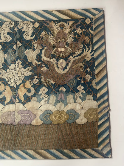 An antique framed Chinese silk kesi of a pair of dragons