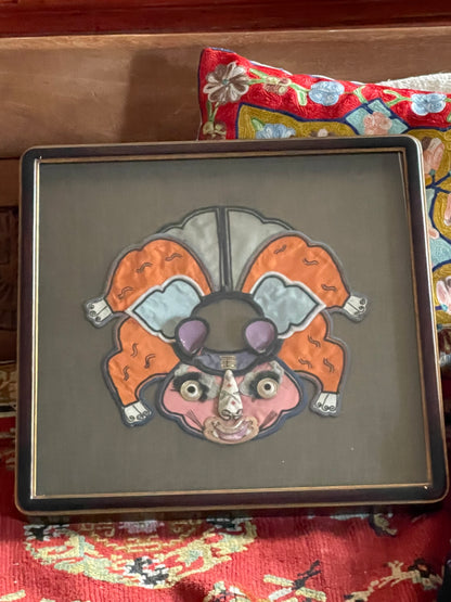 An antique childrens collar with an animal design in a box frame