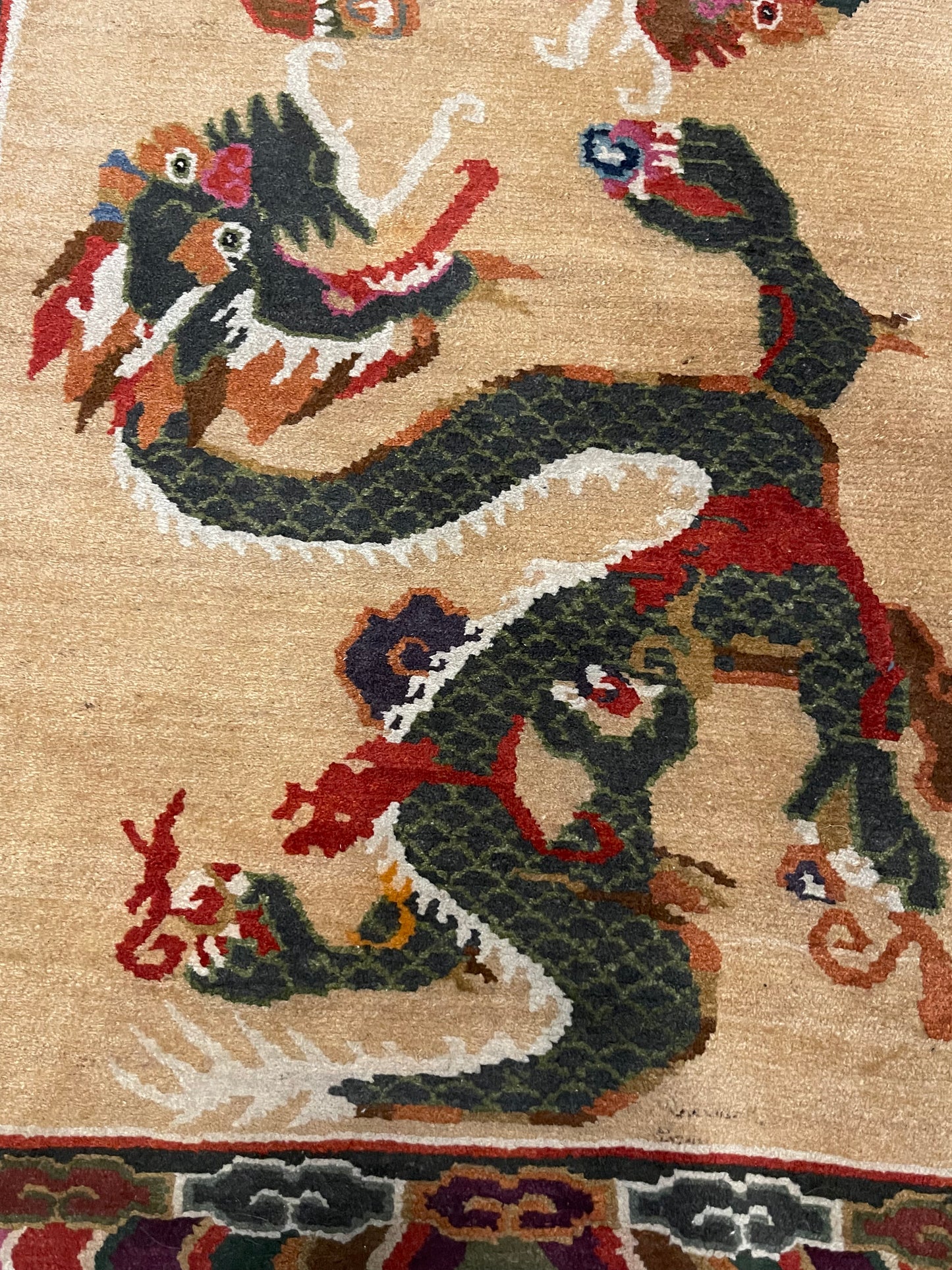 A vintage mid 20th c. Tibetan rug with dragons